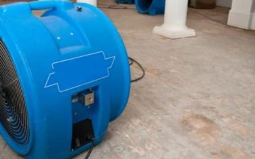 Fans drying water from house flooding
